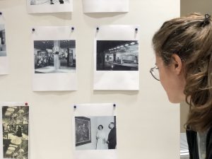 Woman looking at old photos pinned to a board
