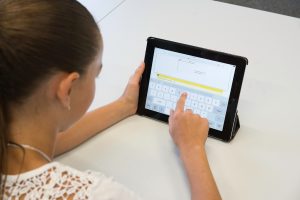 child taking assessment on tablet
